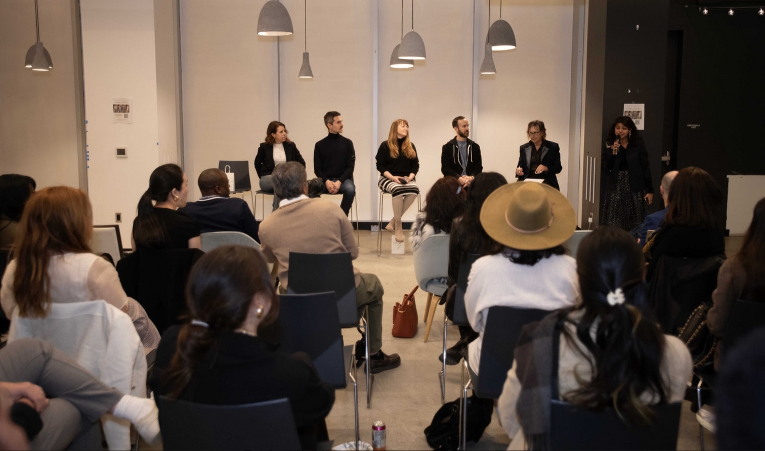 A panel of designers in front of a seated audience at SF Fashion Week