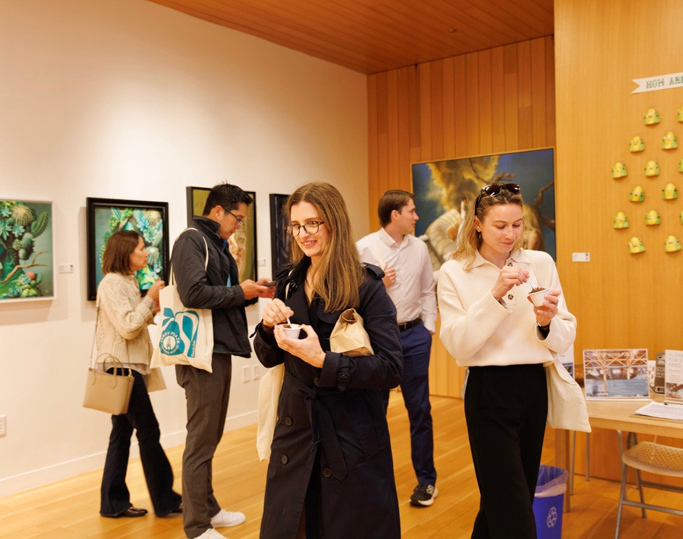 Visitors viewing artwork inside the smArt Collective boxcar gallery