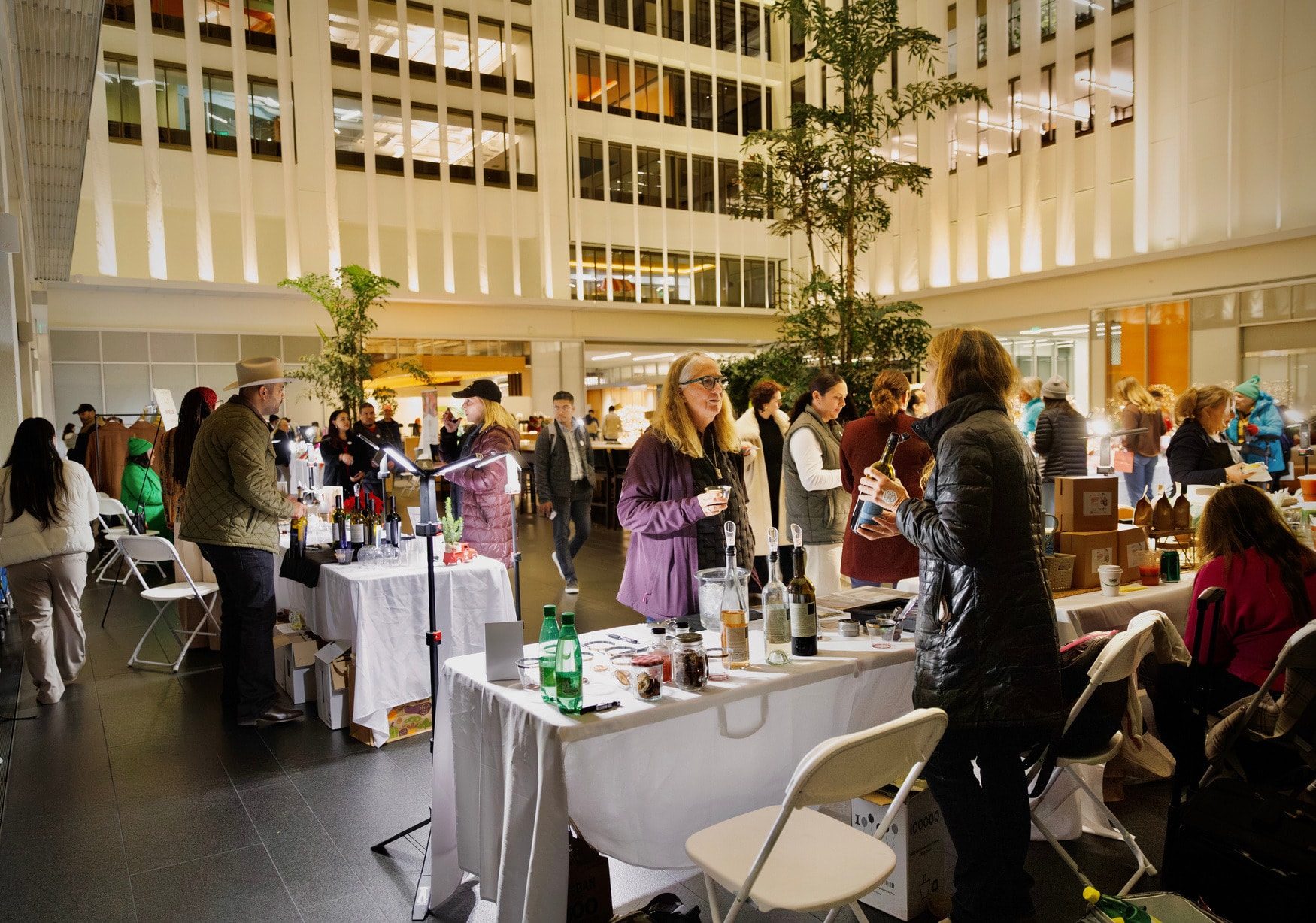 Tenants browsing market stalls across the atrium during Winter Week